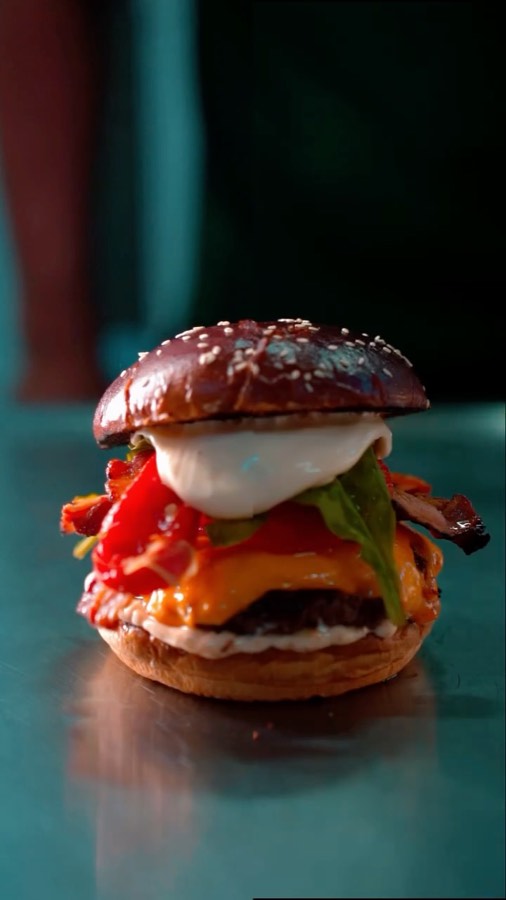 Hambúrguer do Floriano Burger sobre mesa colorida